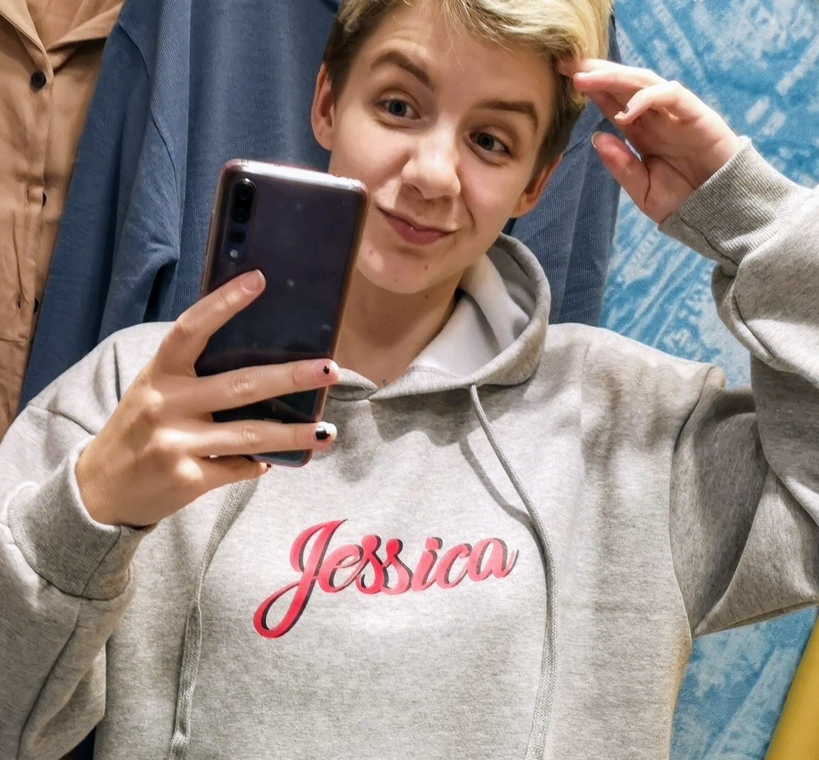Someone wearing a shirt spelling out the name Jessica over the chest